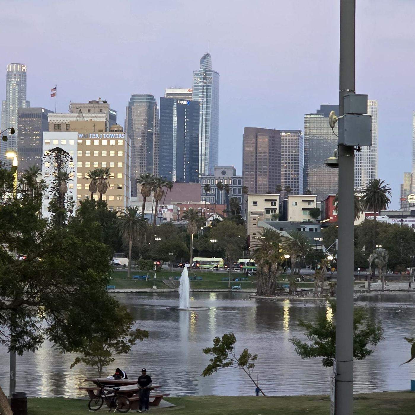 Downtown Los Angeles skyline at dusk, seen across the lake at MacArthur Park