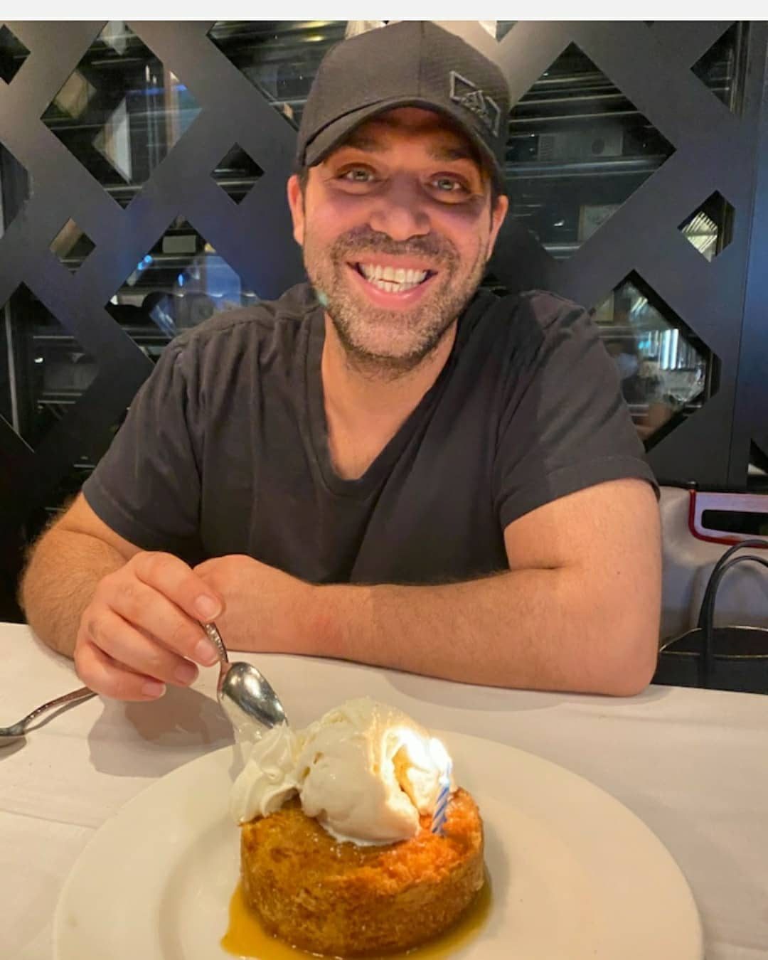 Yaniv Hamudot smiling over a birthday dessert in October 2020
